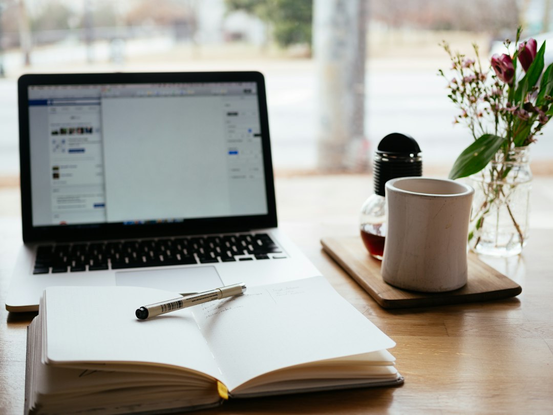 Laptop and notebook representing course and digital product creation inside an all-in-one platform