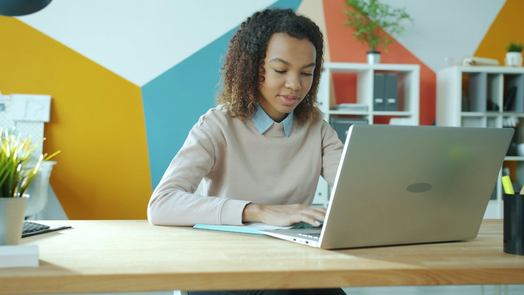 Online business owner working on a laptop while developing a digital product