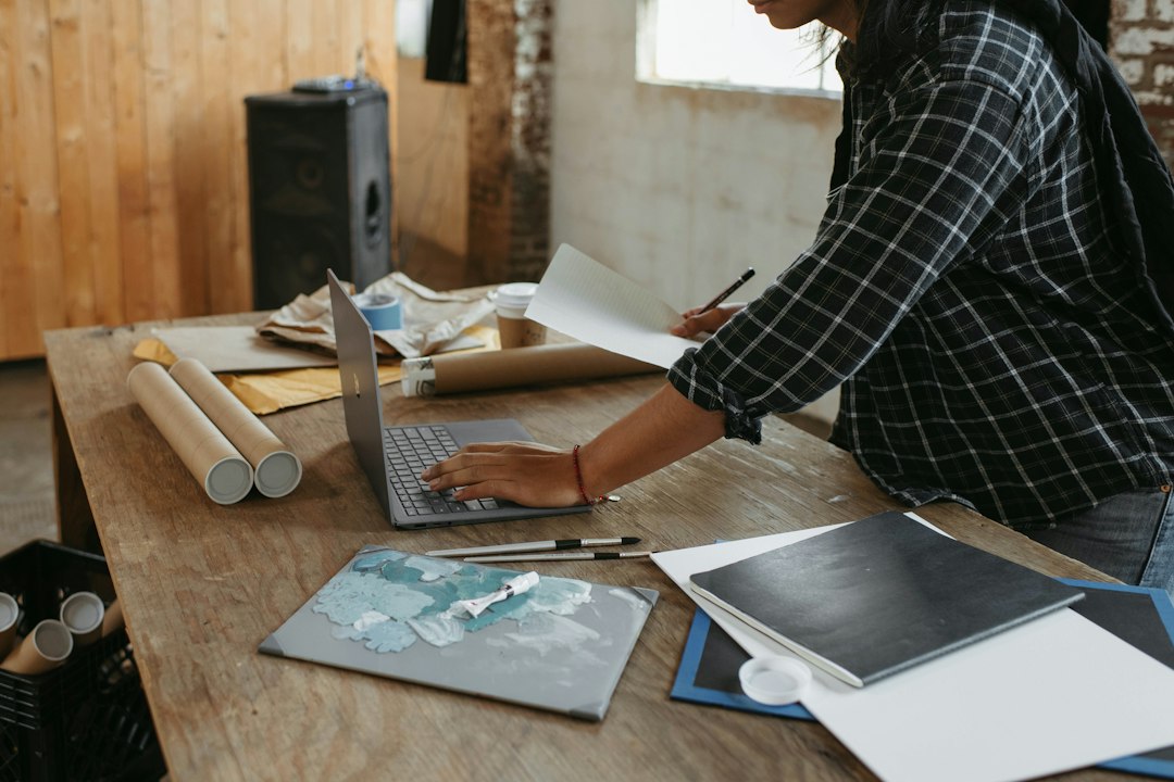 Creator working at a laptop while planning an online product strategy